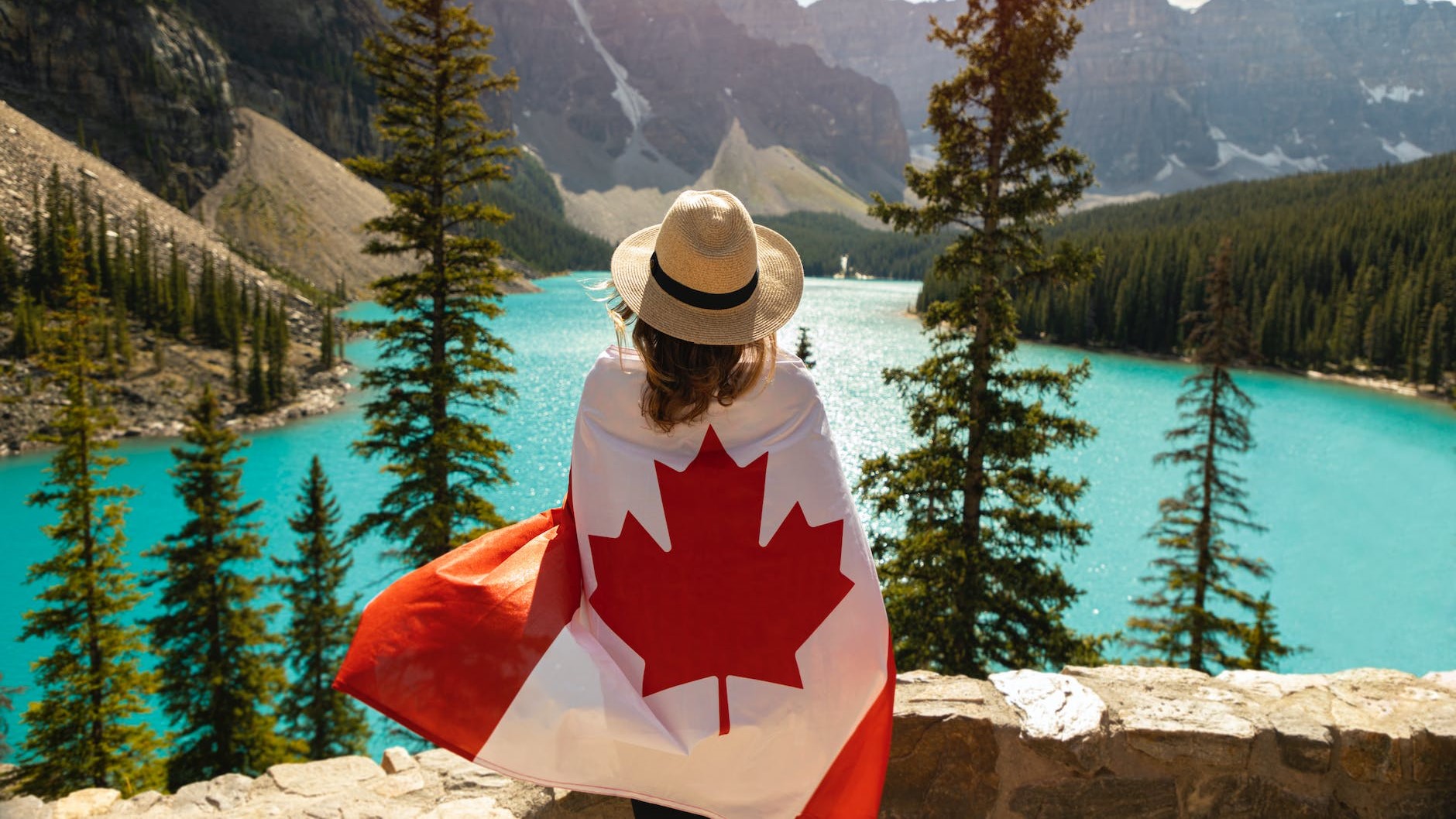 Girl Holding Canada Flag & in front of lake Canada