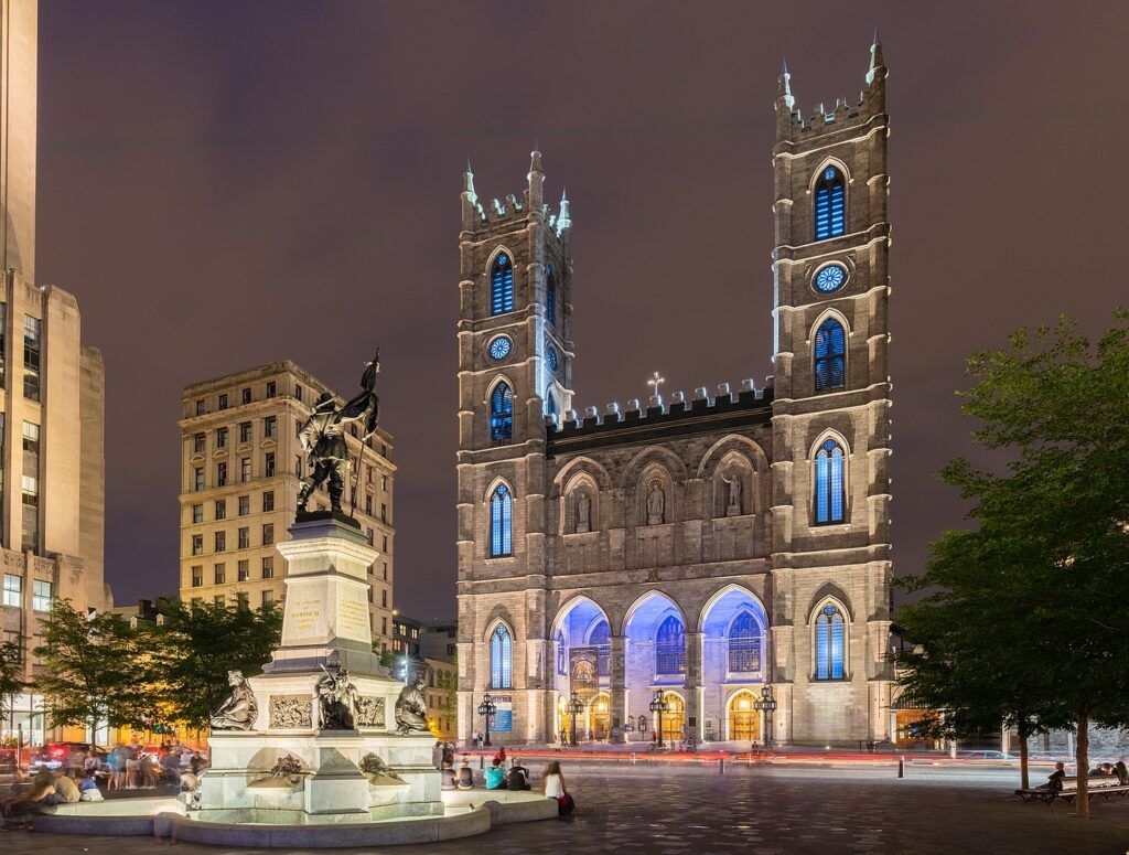 View of the Notre-Dame Basilica from Place d'Armes. The number of churches in Montreal led it to be called "the city of a hundred steeples".